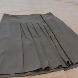 TAHARI skirt.  A-line with asymmetrical pleats and front zip. Gray. Size 14.